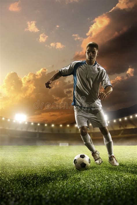 Soccer Player In Action On Sunset Stadium Panorama Background Stock