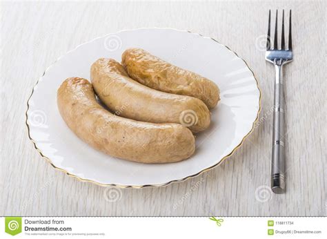 Grilled Chicken Sausages In Plate And Fork On Table Stock Photo Image