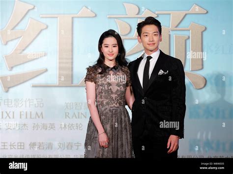 South Korean Singer And Actor Rain Right And Chinese Actress Liu Yifei Pose During A Premiere