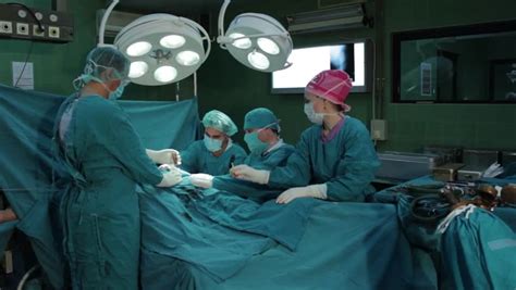 Surgeons Team Performing Operation In Hospital Operation Roomnurse