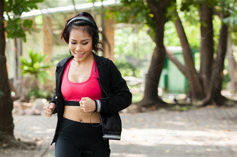 Asian Woman Jogger Listening To Music And Running In The Outdoor Park Female People Images