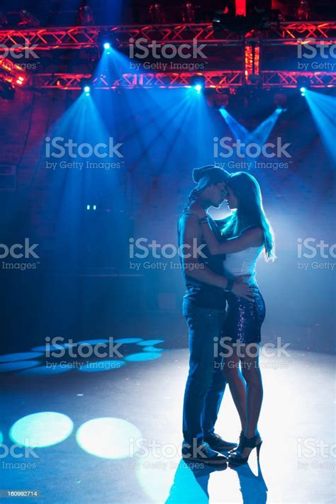 Couple Dancing And Hugging On Empty Dance Floor In Nightclub Stock