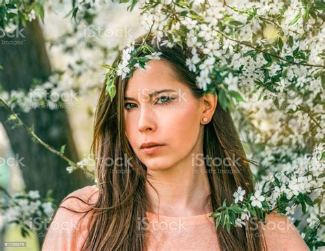 Beautiful Young Brunette Girl In A Blooming Cherry Orchard Happy