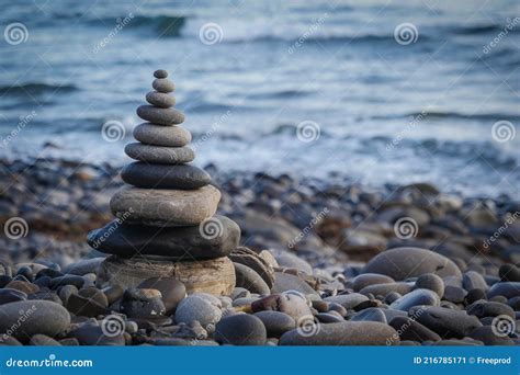 Stone Piles Made Along A Beach And The Sea In The Background Stock