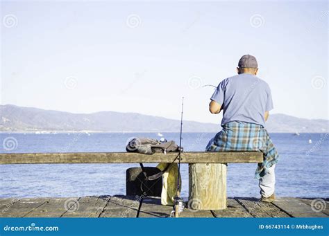 Man Fishing On Dock Stock Photo Image Of Hobby Casting 66743114