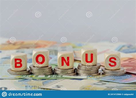 Wooden Blocks With The Word Bonus On Coins And Banknotes Concept Of