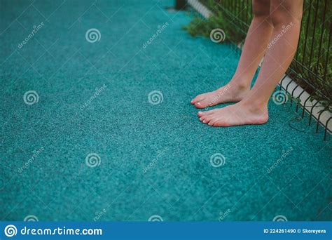 Close Up Of Barefoot Childrens Feet In The Summer On The Playground