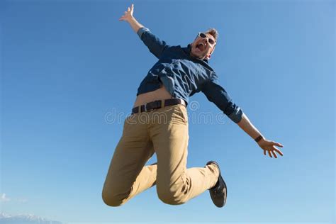 Casual Man Jumps In Mid Air Stock Photo Image Of Beautiful Posing