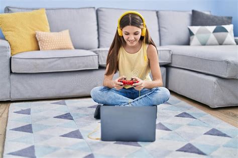 adorable girl playing video game sitting on floor at home stock image image of sofa happy