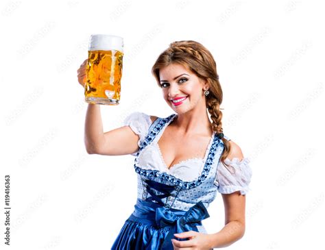 woman in traditional bavarian dress holding mug of beer stock foto adobe stock