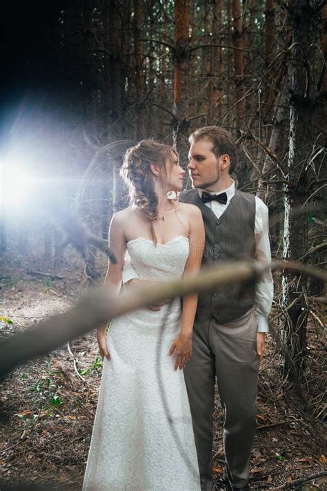 Dramatic Picture Bride And Groom On The Background Of Leaves Forest
