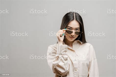 Portrait Of A Asian Girl On A Light Background Asian Girl With Glasses