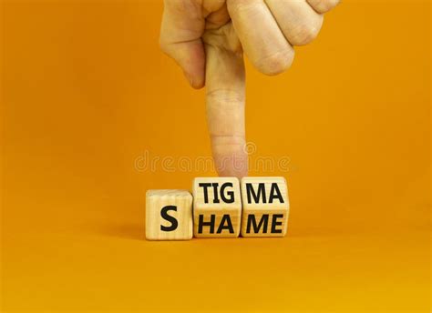 stigma or shame symbol concept words stigma or shame on wooden cubes businessman hand stock