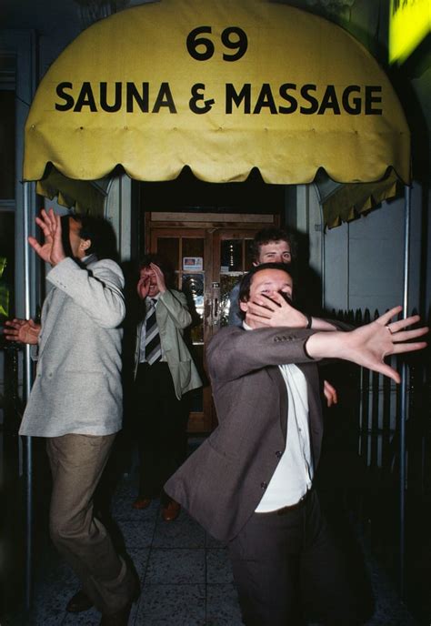 Men Hiding Their Faces Exiting 69 Sauna And Massage In Soho London