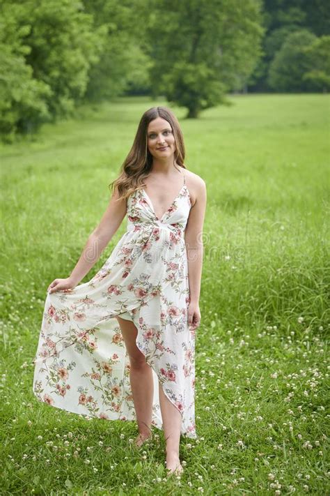 Beautiful Young Woman Walking In Sundress In Field Of Grass Stock Image