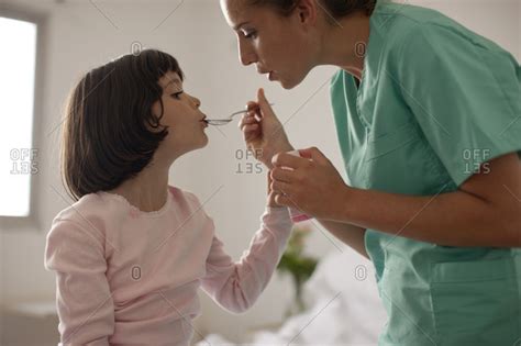 Nurse Giving A Babe Patient A Dose Of Medicine Stock Photo OFFSET