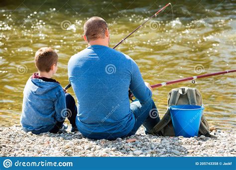 Portrait Of Father And Son Fishing With Rods Stock Photo Image Of