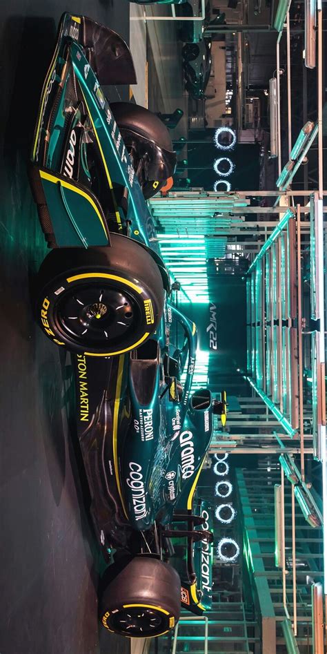 The Interior Of A Race Car Is Lit Up With Green And Yellow Lights As It