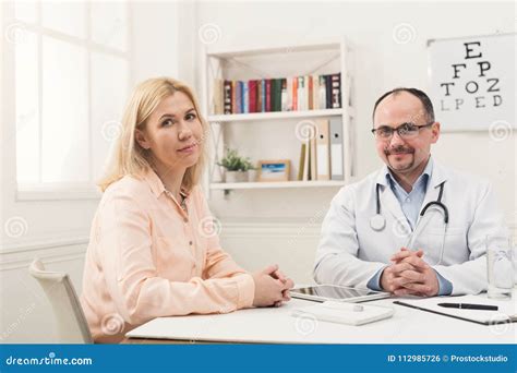 Happy Doctor Consulting Woman In Hospital Stock Photo Image Of