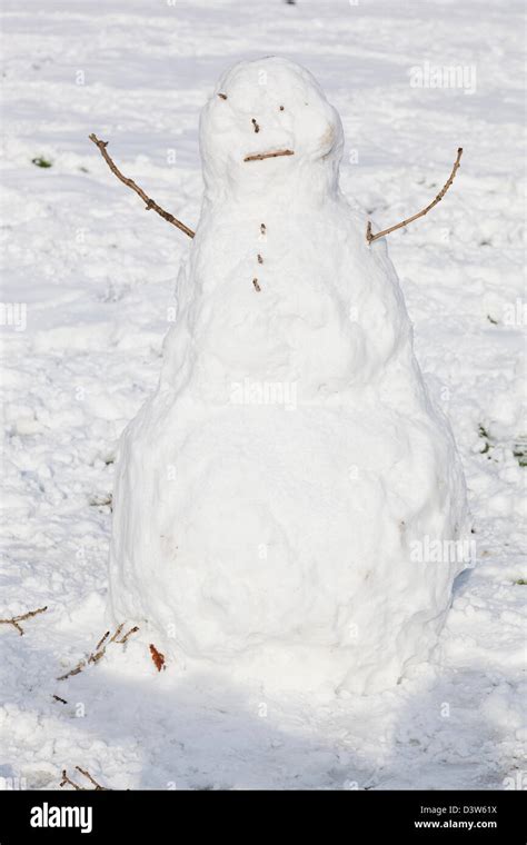 Snowman With Twigs For Arms Eyes Nose And Mouth Stock Photo Alamy