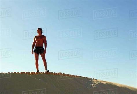 Man Standing On A Beach Stock Photo Dissolve