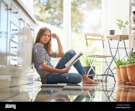 Comfortable In The Kitchen Portrait Of An Attractive Young Woman