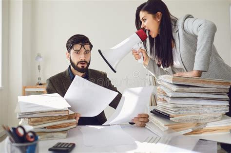 Angry Boss Businesswoman Shouting At Her Office Worker In A Megaphone