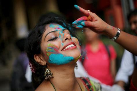 A Woman Gets Colored On Holi Holi Festival Holi Festival Photography