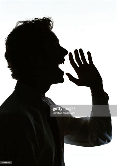 Man Yelling With Hand Out In Front Of Mouth Silhouette Bildbanksbilder