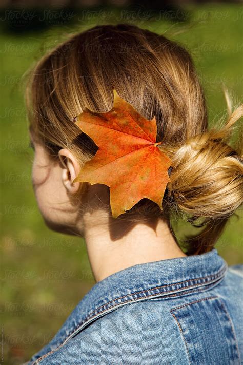 woman with autumn leaf in hair by stocksy contributor danil nevsky stocksy