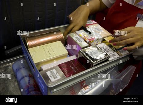 Member Of Cabin Crew With Duty Free Trolley To Sell Goods To Stock