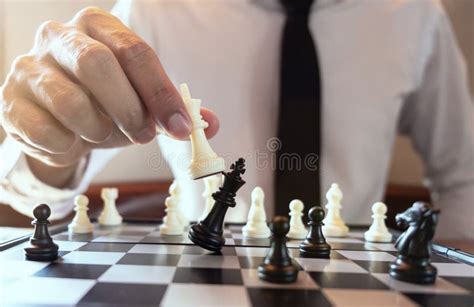 Closeup Photo Of Businessman Playing Chess And Beating Black Kin Stock