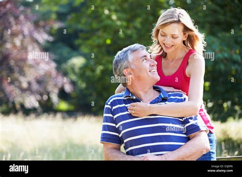 Romantic Middle Aged Couple Walking In Countryside Stock Photo Alamy