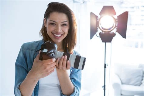 Premium Photo Happy Female Photographer Standing In Studio