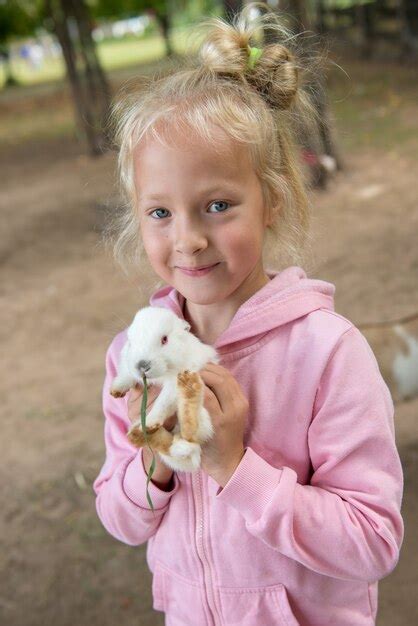 Premium Photo Small Blonde Girl With White Rabbit