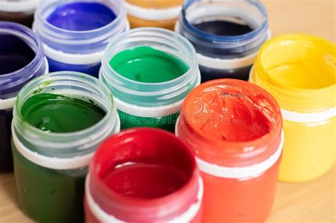 Paint Brushes And Watercolor Paints Tempera Paints On The Table In A