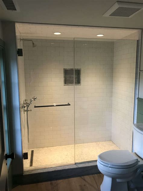 frameless shower door and panel with towel bar by absolute shower doors