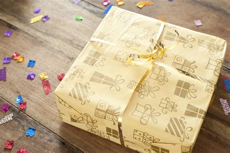 Free Stock Photo 11416 Yellow Present on Wooden Table with Confetti ...