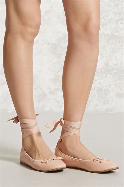 A Pair Of Faux Leather Ballet Flats Complete With Lace Up Self Tie Straps At The Ankles And A