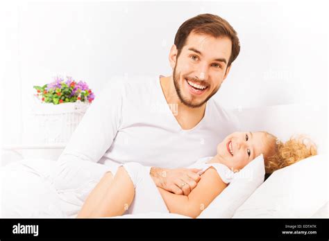 Father Hugs Cute Daughter And Laying On Bed Stock Photo Alamy