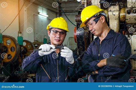 Asian Engineer Safety Uniforms Use Vernier Calipers To Measure