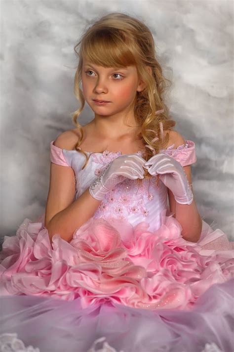 Portrait Of Adorable Smiling Little Girl In Princess Dress Stock Photo