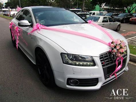 However, decorating the wedding car with tin cans is not the only way to embellish it. White Audi S5 Wedding Car Decorations by Ace Drive Car Rental