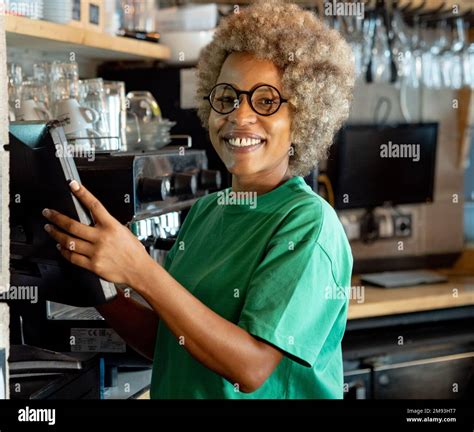 Portrait Of An African American Waitress In A Pub At The Cash Register