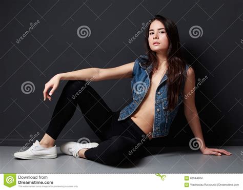 Young Brunette Woman Sitting On The Floor Cheeky Pose Stock Photo