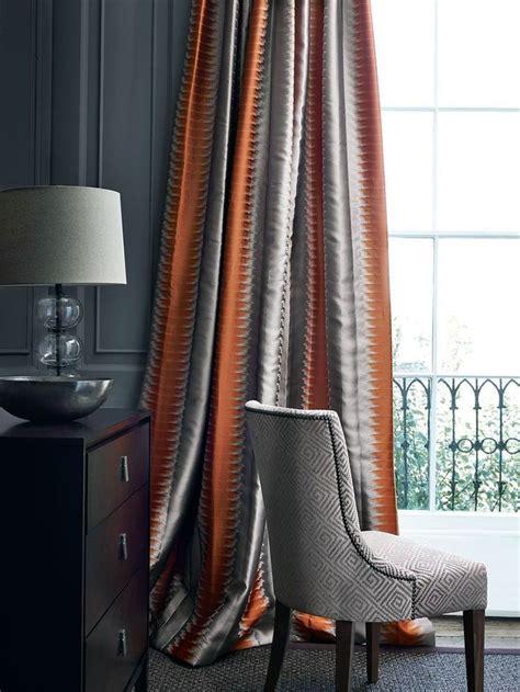 Different shades of brown on the walls and floor provide a relaxing warmth, while the turquoise accessories and striped curtains give the room a pop of color and. Discover burnt orange living room ideas only in times home design | Orange curtains living room ...