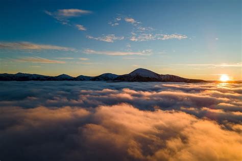 Premium Photo Aerial View Of Vibrant Sunrise Over White Dense Clouds