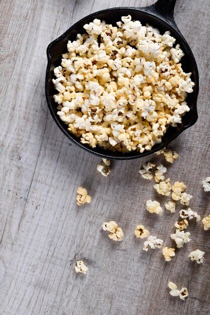 Premium Photo Air Salty Popcorna Bowl Of Popcorn On A Wooden Table