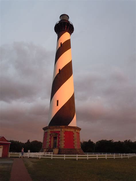 The Lighthouse Is Lit Up At Night Time