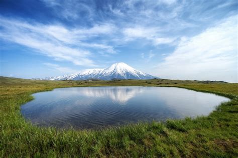 Premium Photo Volcano And Lake With Reflection In Water In Russia On